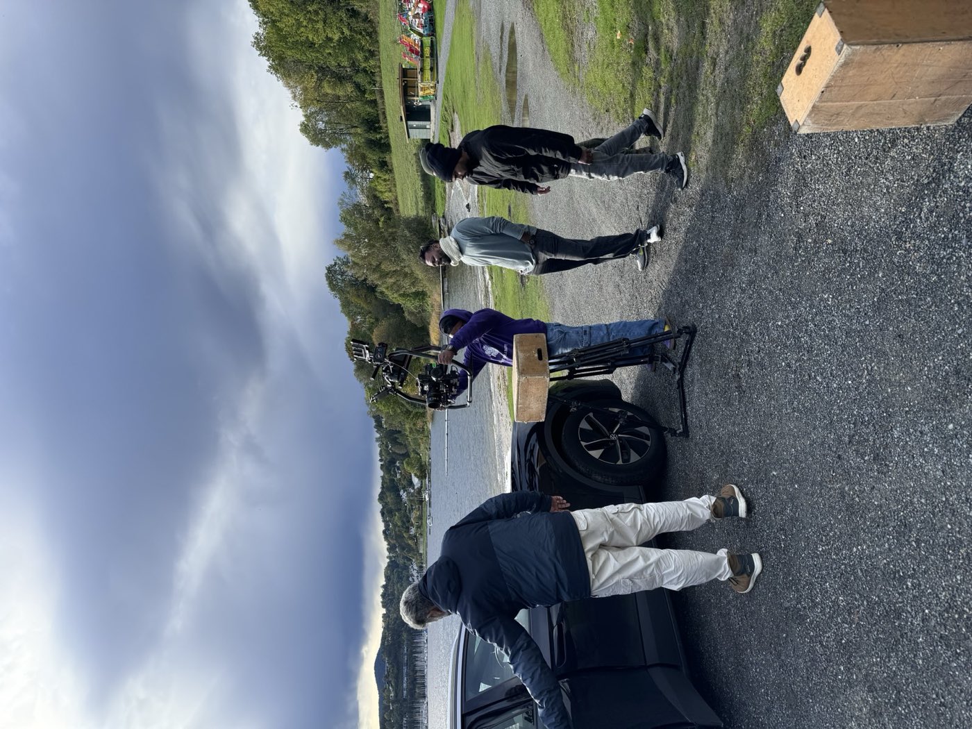 Crew setting up a camera rig on location beside a Norwegian lake