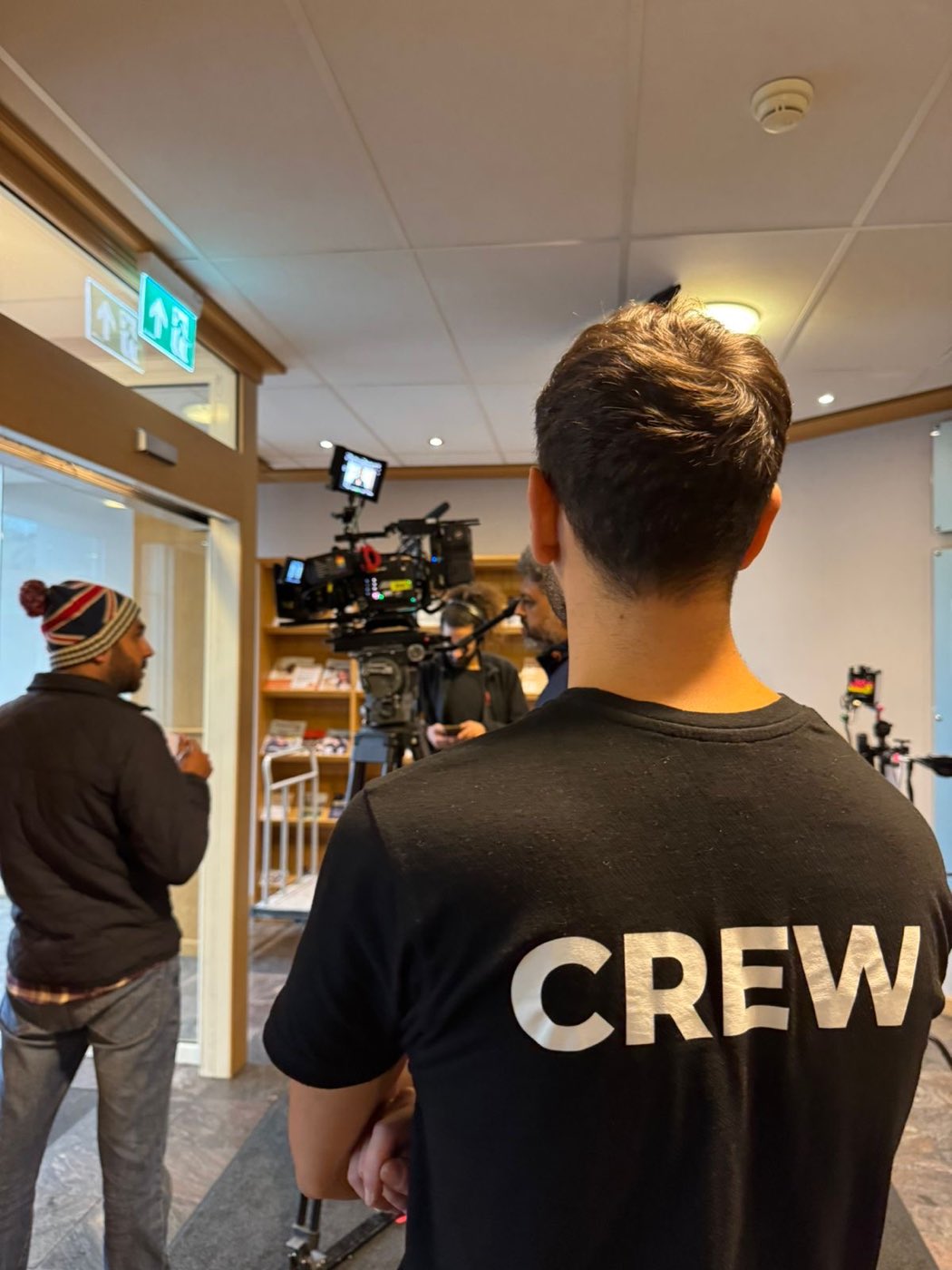 Crew member and cinema camera during an interior setup on a Norwegian location