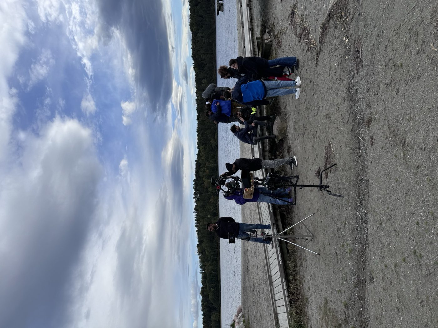 International film crew and camera setup on a lakeshore in Norway during the Butta Bond production